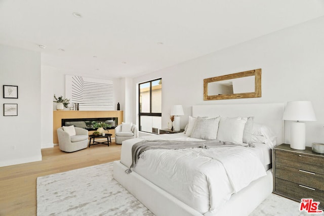 bedroom with light hardwood / wood-style flooring