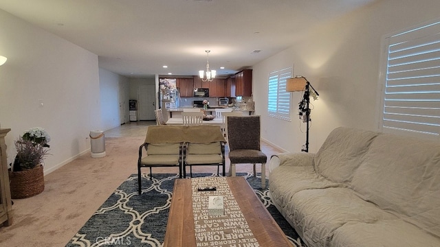 living room with a notable chandelier and light carpet