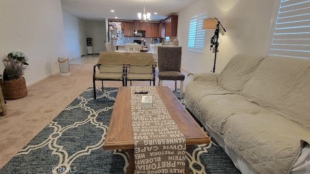 living room with light carpet and a chandelier