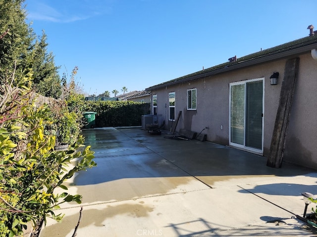 exterior space with central AC and a patio