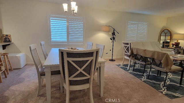 dining space featuring carpet floors and an inviting chandelier