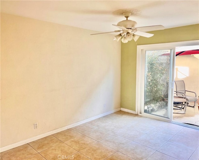 tiled empty room featuring ceiling fan