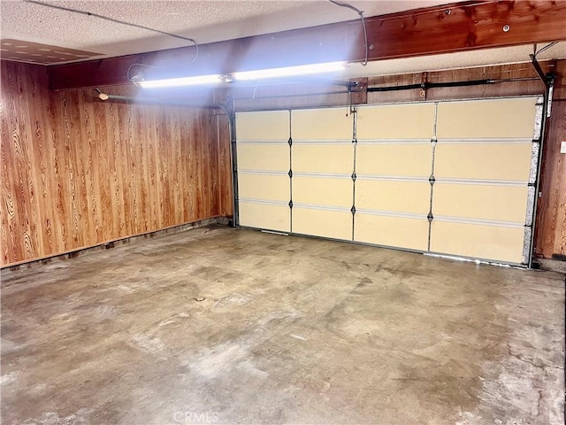 garage featuring wood walls