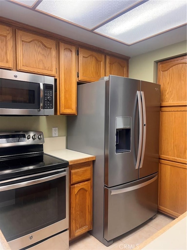 kitchen with stainless steel appliances and light tile patterned floors