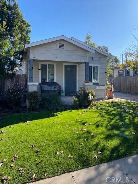 view of front of property with a front yard and a porch