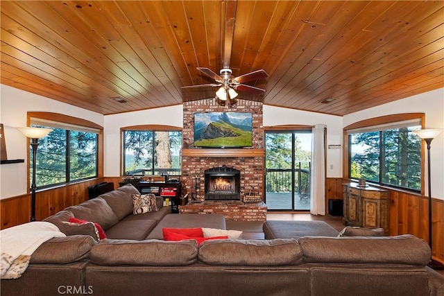 living room featuring lofted ceiling, wood walls, and wooden ceiling