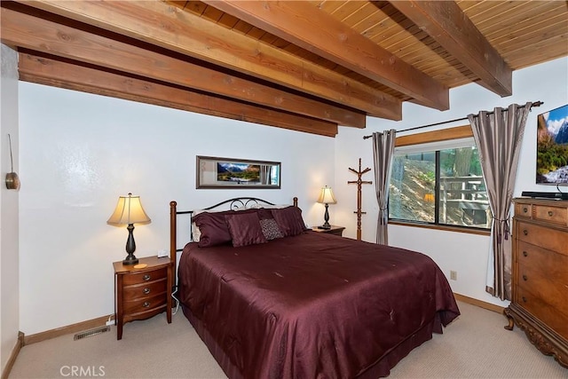 carpeted bedroom featuring beam ceiling and wooden ceiling