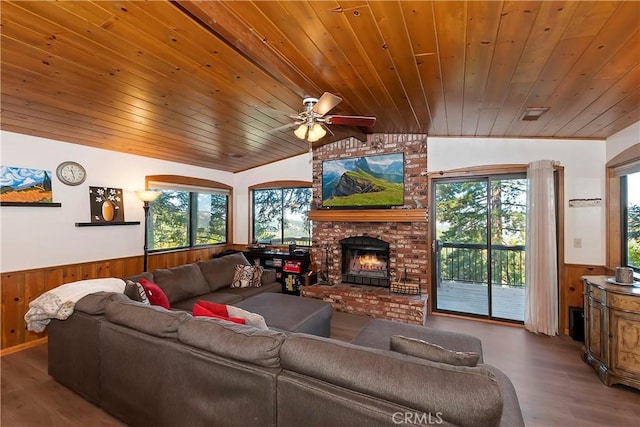 living room featuring lofted ceiling, wood ceiling, a fireplace, ceiling fan, and light hardwood / wood-style flooring