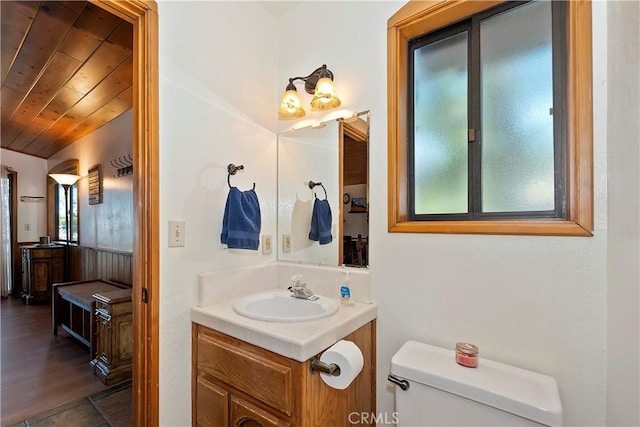 bathroom featuring toilet, wooden ceiling, lofted ceiling, and vanity