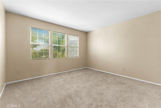 spare room with light colored carpet