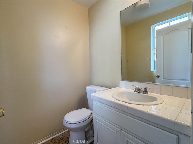 bathroom featuring tile patterned flooring, vanity, and toilet