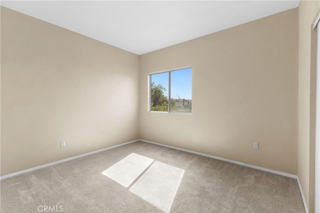 unfurnished room featuring light colored carpet