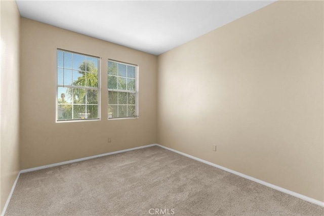 unfurnished room with light colored carpet