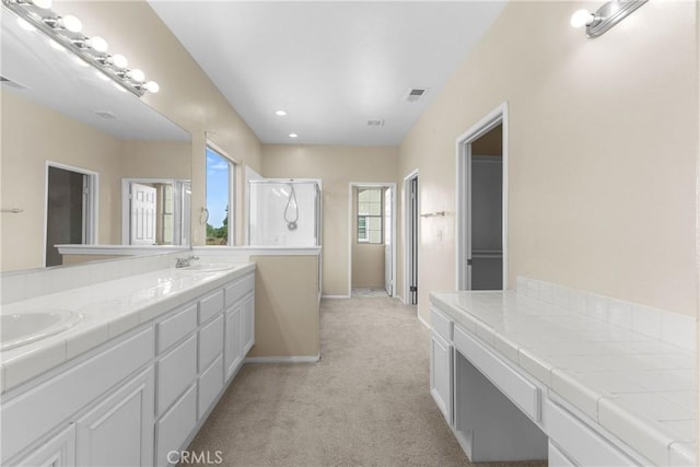 bathroom with vanity and a shower with door