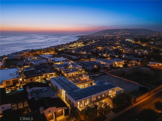 aerial view at dusk with a water view