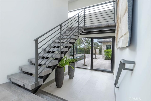 staircase with a towering ceiling