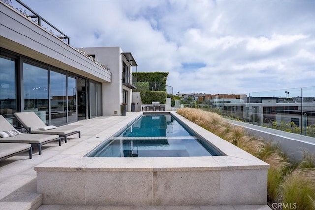 view of swimming pool with a patio area and an in ground hot tub