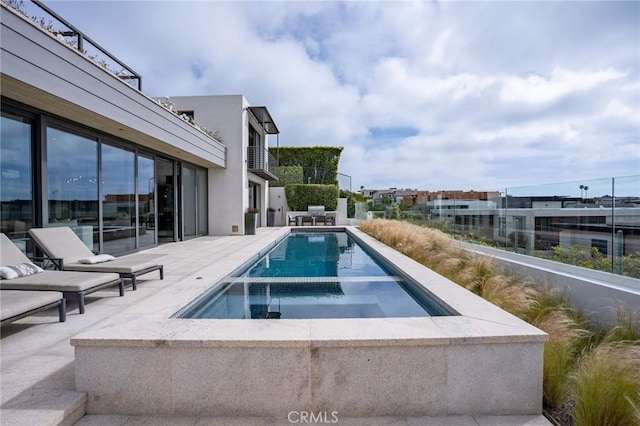 view of pool with a patio and a pool with connected hot tub