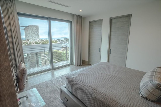 bedroom featuring light hardwood / wood-style floors and access to exterior