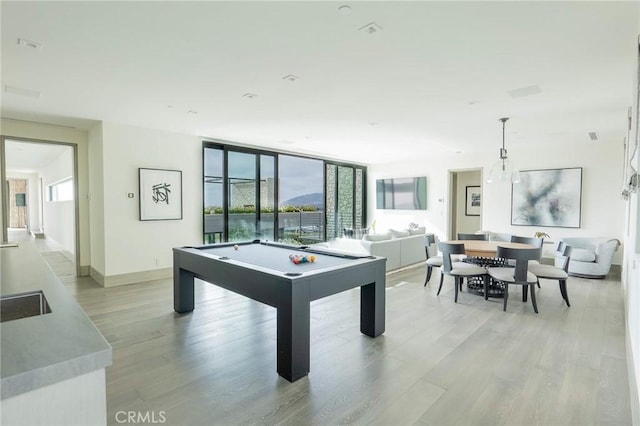 playroom with pool table, light wood-type flooring, and a wealth of natural light