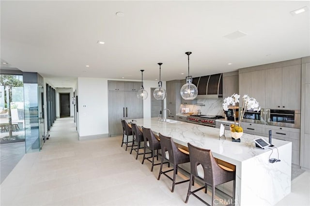 kitchen with a large island, gray cabinets, and appliances with stainless steel finishes