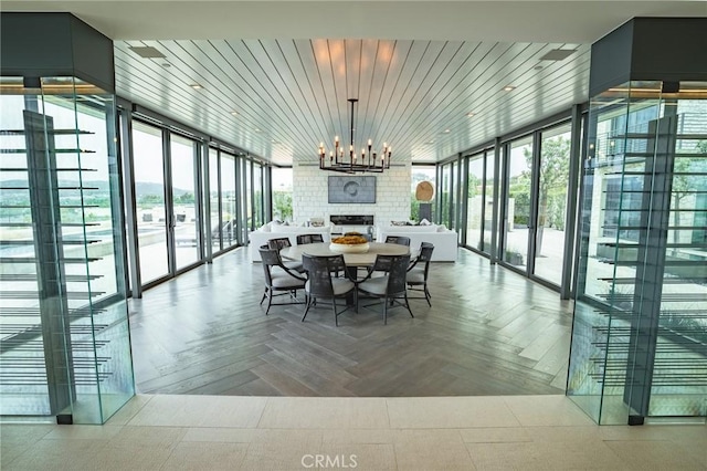 dining room with a chandelier and floor to ceiling windows