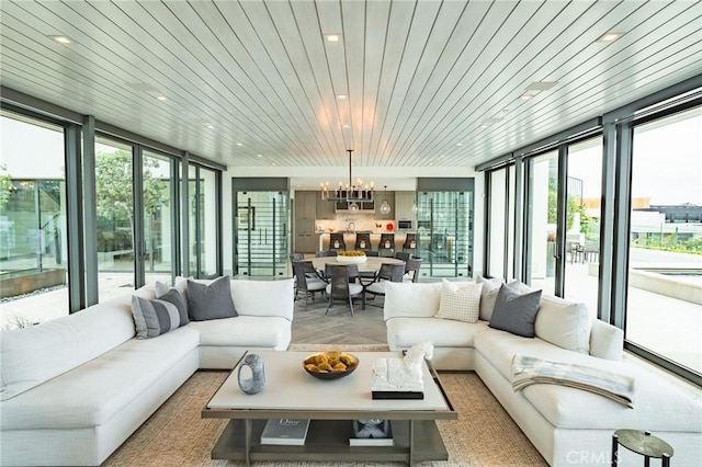 sunroom / solarium with wooden ceiling and a notable chandelier