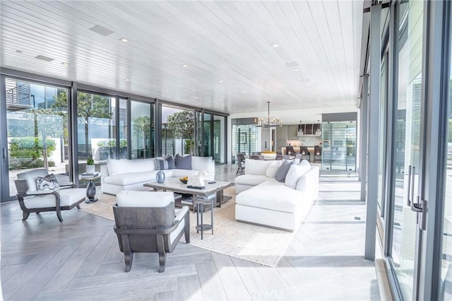 interior space featuring an inviting chandelier, wood ceiling, and a healthy amount of sunlight