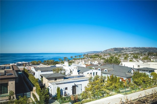 exterior space with a residential view and a water view