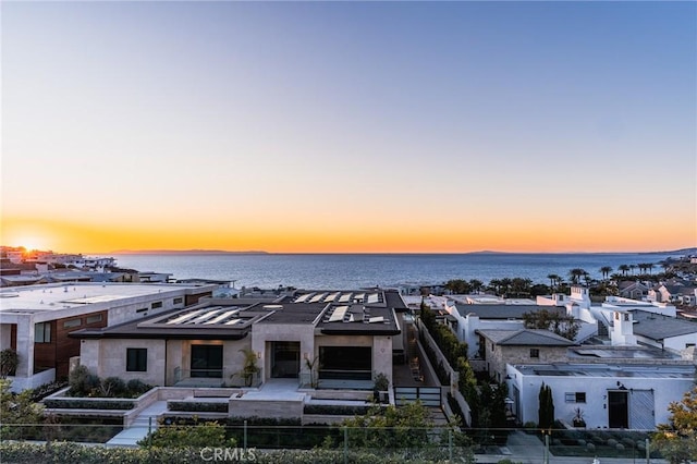 aerial view at dusk with a water view