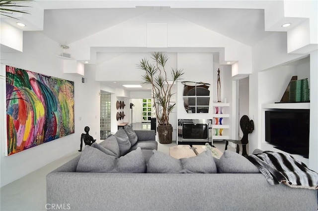 living room featuring built in shelves and lofted ceiling