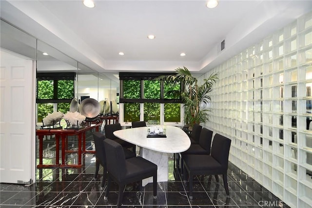 dining area with a tray ceiling