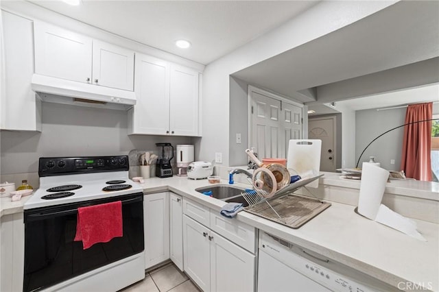 kitchen featuring white cabinetry, white appliances, sink, and light tile patterned floors