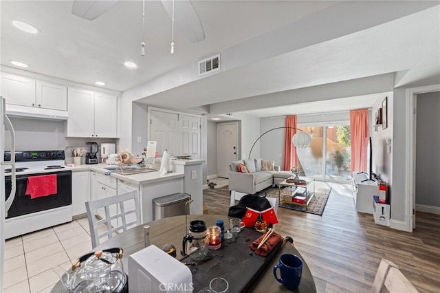 kitchen with white cabinets, white range with electric stovetop, and sink