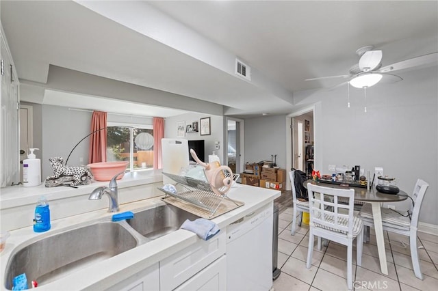 kitchen featuring white cabinets, white dishwasher, sink, ceiling fan, and light tile patterned flooring