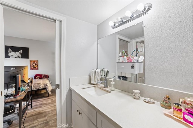 bathroom with vanity and hardwood / wood-style flooring