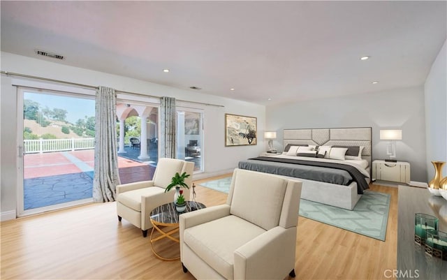 bedroom featuring access to exterior and light wood-type flooring