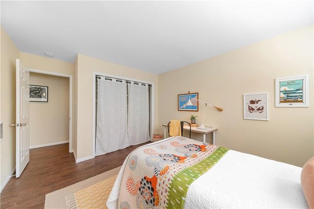 bedroom featuring dark hardwood / wood-style floors and a closet