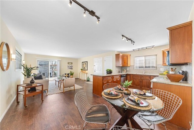 dining space with sink and dark wood-type flooring