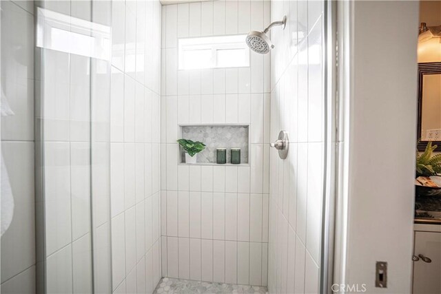 bathroom featuring a shower with door