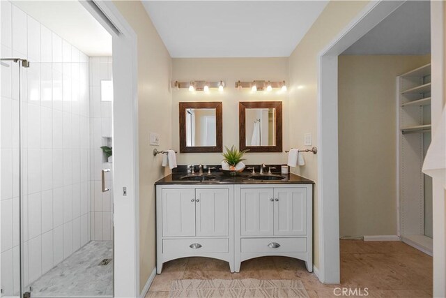 bathroom featuring vanity, tile patterned flooring, and walk in shower