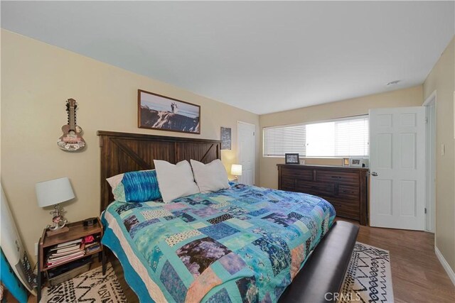 bedroom with wood-type flooring