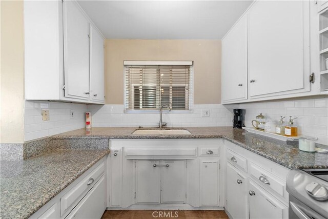 kitchen featuring white cabinetry, light stone countertops, sink, and electric stove