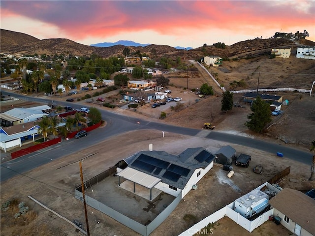 aerial view at dusk featuring a mountain view