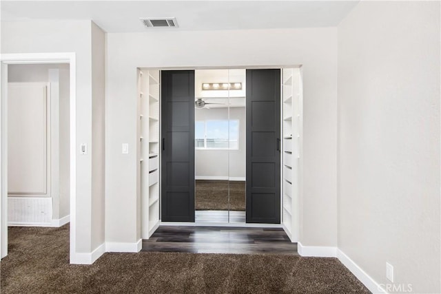 entryway featuring dark colored carpet