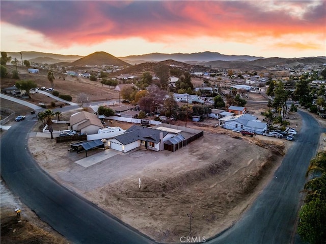 aerial view at dusk featuring a mountain view