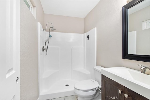 bathroom with toilet, a shower, vanity, and plenty of natural light