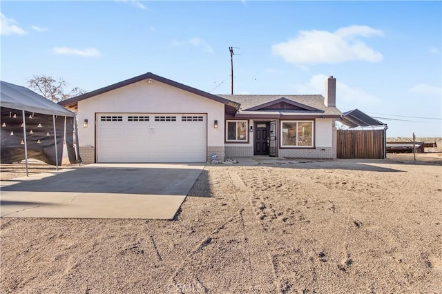 ranch-style home featuring a carport and a garage