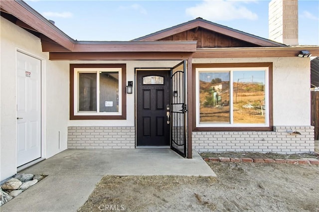 property entrance featuring a patio area