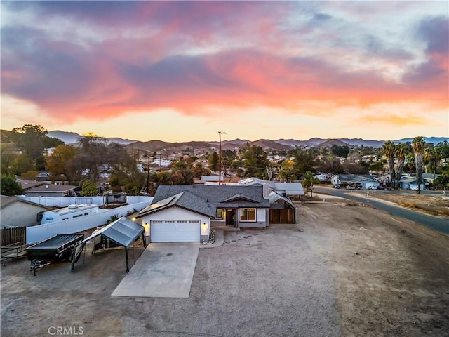 aerial view at dusk featuring a mountain view